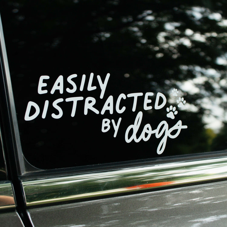 Easily Distracted Decal by Decals featuring a playful design with the phrase "Easily Distracted" on a clear background.